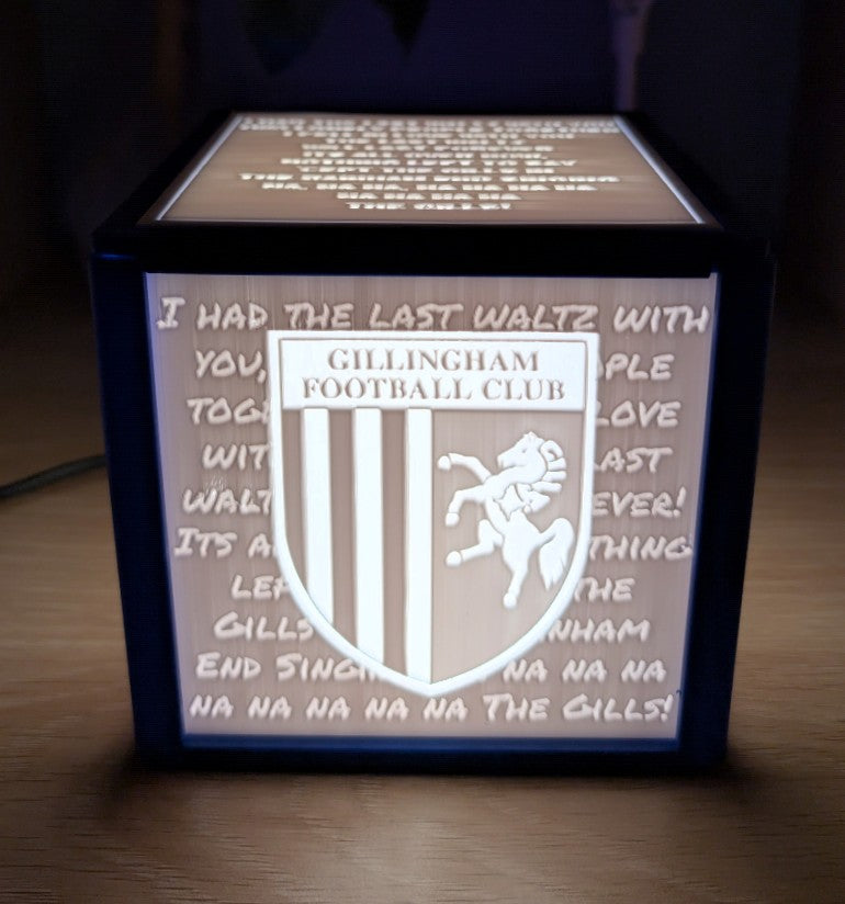 Light-up box with Gillingham Football Club logo and text on a wooden surface