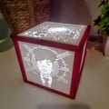 Decorative light box with engraved design on a white surface feat Ren Gill a Music artist frm Brighton